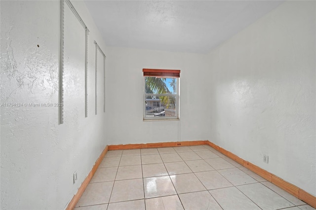 4241 W 1st Ave, Hialeah, FL 33012 - empty room with light tile patterned floors and baseboards