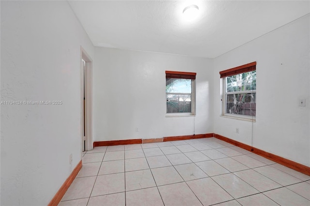 4241 W 1st Ave, Hialeah, FL 33012 - empty room featuring light tile patterned floors and baseboards