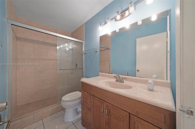 4241 W 1st Ave, Hialeah, FL 33012 - bathroom featuring vanity, tile patterned floors, a shower stall, and toilet