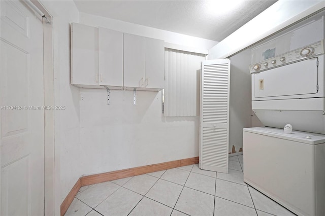 4241 W 1st Ave, Hialeah, FL 33012 - laundry room with laundry area, baseboards, light tile patterned floors, and stacked washer / dryer