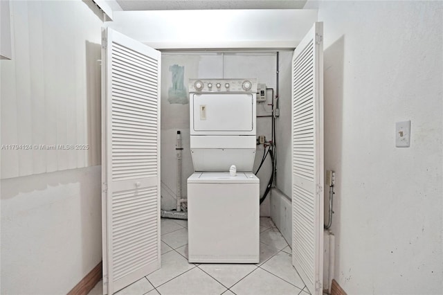 4241 W 1st Ave, Hialeah, FL 33012 - laundry area featuring laundry area, light tile patterned flooring, and stacked washer / dryer