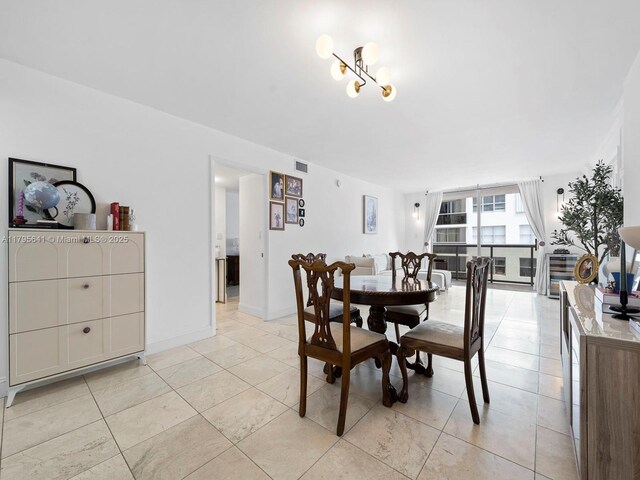 6039 Collins Ave Unit 1015, Miami Beach, FL 33140 - dining area with light tile patterned floors and visible vents