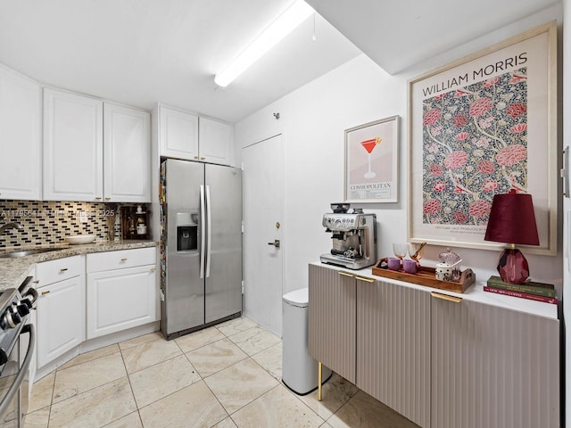 6039 Collins Ave Unit 1015, Miami Beach, FL 33140 - kitchen with a sink, appliances with stainless steel finishes, tasteful backsplash, and white cabinetry