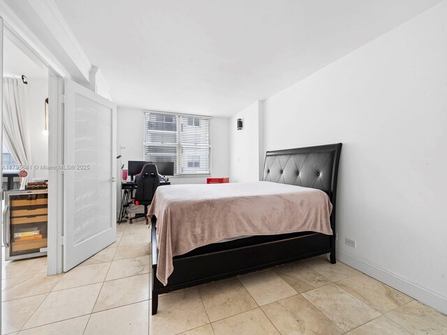 6039 Collins Ave Unit 1015, Miami Beach, FL 33140 - bedroom with beverage cooler, baseboards, and light tile patterned floors