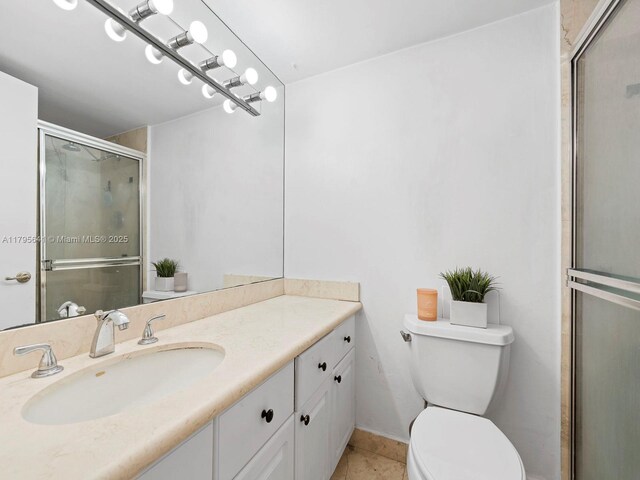6039 Collins Ave Unit 1015, Miami Beach, FL 33140 - full bath with vanity, tile patterned floors, a stall shower, and toilet