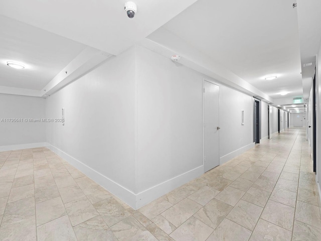 6039 Collins Ave Unit 1015, Miami Beach, FL 33140 - corridor featuring baseboards and a raised ceiling