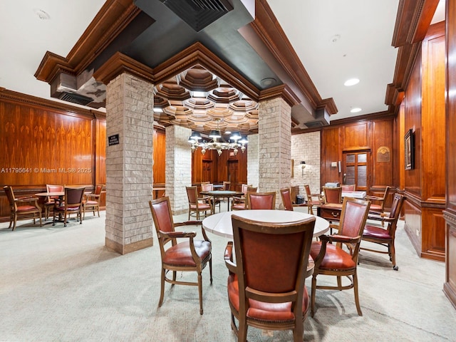 6039 Collins Ave Unit 1015, Miami Beach, FL 33140 - dining room featuring crown molding, wooden walls, an inviting chandelier, light carpet, and ornate columns