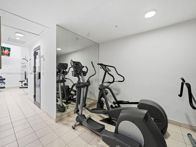 6039 Collins Ave Unit 1015, Miami Beach, FL 33140 - exercise room featuring baseboards and tile patterned flooring