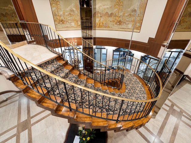 6039 Collins Ave Unit 1015, Miami Beach, FL 33140 - stairway with baseboards, a high ceiling, and a chandelier