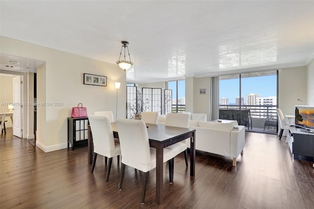 3300 NE 191st St Unit 07, Aventura, FL 33180 - dining area featuring dark wood-type flooring, expansive windows, and baseboards