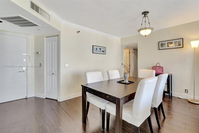 3300 NE 191st St Unit 07, Aventura, FL 33180 - dining area featuring wood finished floors, baseboards, and crown molding