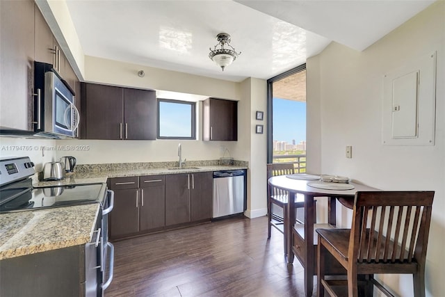 3300 NE 191st St Unit 07, Aventura, FL 33180 - kitchen with stainless steel appliances, healthy amount of natural light, and dark brown cabinetry