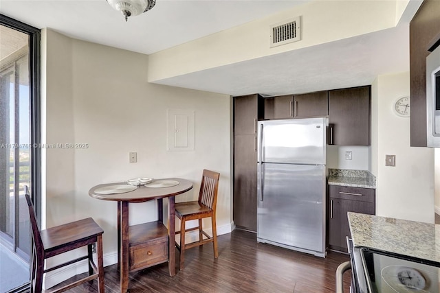 3300 NE 191st St Unit 07, Aventura, FL 33180 - kitchen with freestanding refrigerator, light countertops, dark wood-style flooring, dark brown cabinets, and black / electric stove