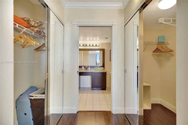3300 NE 191st St Unit 07, Aventura, FL 33180 - hallway with wood finished floors, baseboards, and ornamental molding