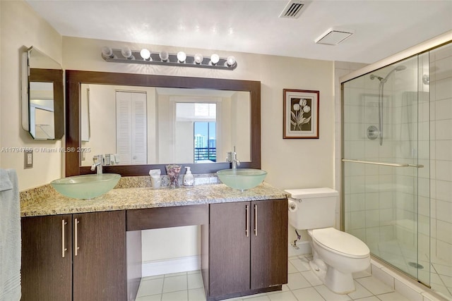 3300 NE 191st St Unit 07, Aventura, FL 33180 - full bathroom featuring toilet, a stall shower, double vanity, and tile patterned floors