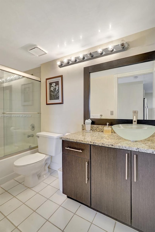 3300 NE 191st St Unit 07, Aventura, FL 33180 - bathroom featuring tile patterned floors, vanity, toilet, and combined bath / shower with glass door