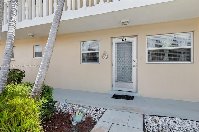2164 NE 1st Way Unit 103, Boynton Beach, FL 33435 - doorway to property with stucco siding