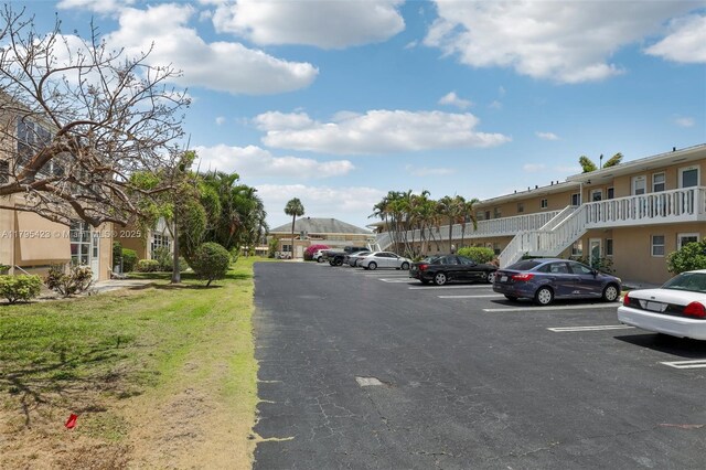 2164 NE 1st Way Unit 103, Boynton Beach, FL 33435 - uncovered parking lot featuring a residential view and stairway