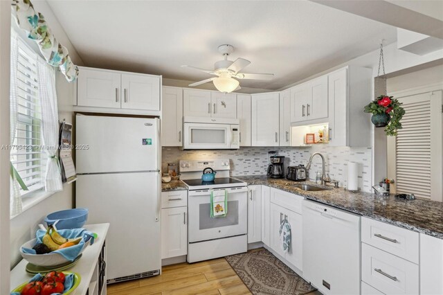 2164 NE 1st Way Unit 103, Boynton Beach, FL 33435 - kitchen with white appliances, a sink, white cabinetry, and tasteful backsplash