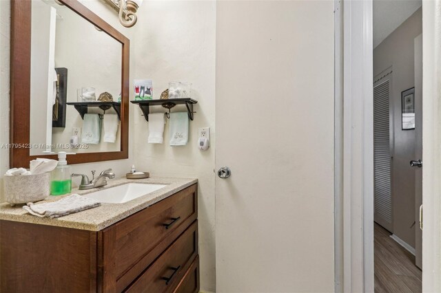 2164 NE 1st Way Unit 103, Boynton Beach, FL 33435 - bathroom with wood finished floors and vanity