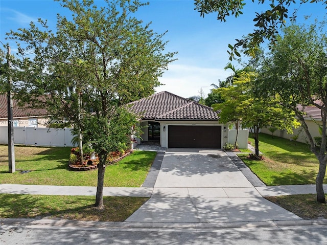 view of front facade with an attached garage, a front lawn, a tile roof, and concrete driveway