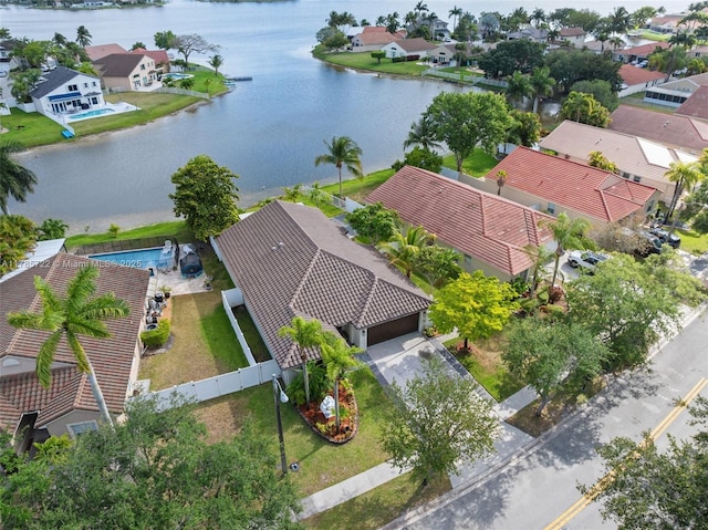 drone / aerial view featuring a residential view and a water view
