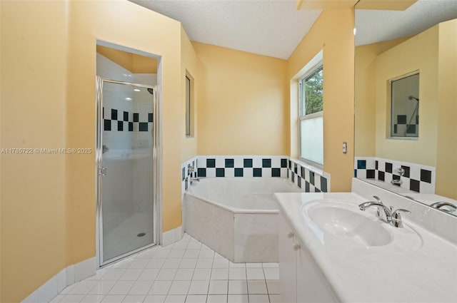 full bathroom featuring vanity, tile patterned flooring, baseboards, a bath, and a shower stall