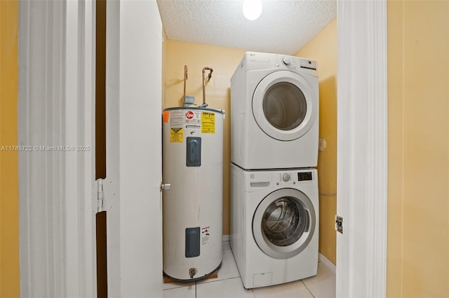 clothes washing area featuring laundry area, light tile patterned flooring, stacked washer / dryer, a textured ceiling, and water heater