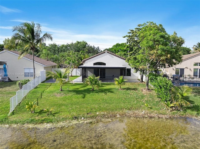 exterior space with fence and a front lawn