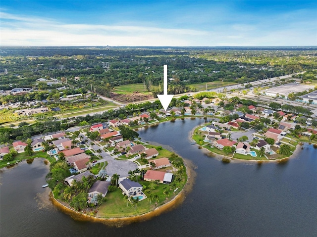 drone / aerial view with a water view and a residential view