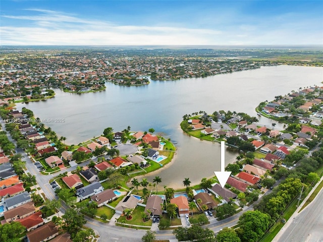 drone / aerial view featuring a water view and a residential view