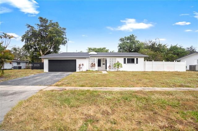 ranch-style house with an attached garage, a front lawn, aphalt driveway, and fence