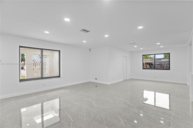 spare room featuring baseboards, marble finish floor, recessed lighting, and visible vents