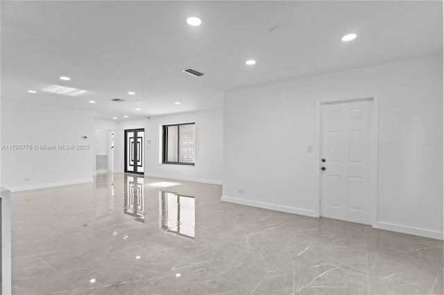 spare room with recessed lighting, baseboards, marble finish floor, and visible vents