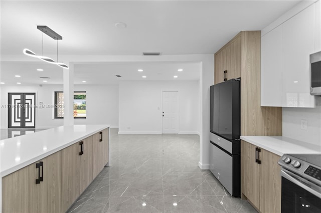 kitchen with light brown cabinetry, appliances with stainless steel finishes, and modern cabinets