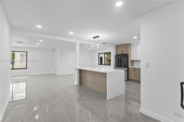 kitchen featuring fridge, marble finish floor, recessed lighting, baseboards, and modern cabinets