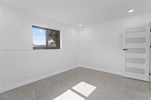 spare room featuring built in features, baseboards, recessed lighting, and marble finish floor