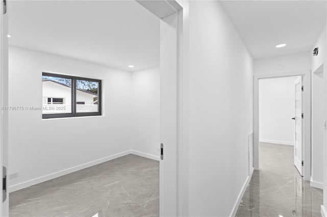 hall featuring recessed lighting, baseboards, and marble finish floor