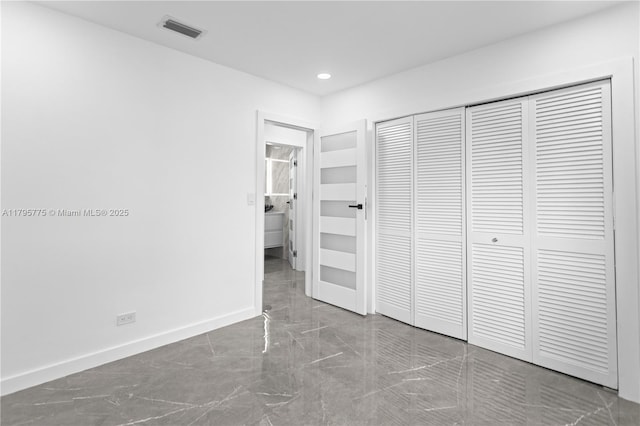 unfurnished bedroom with marble finish floor, recessed lighting, baseboards, visible vents, and a closet