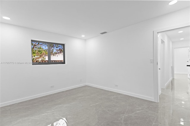 spare room featuring recessed lighting, baseboards, and visible vents