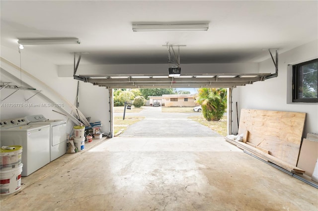 garage with a garage door opener and washer and clothes dryer