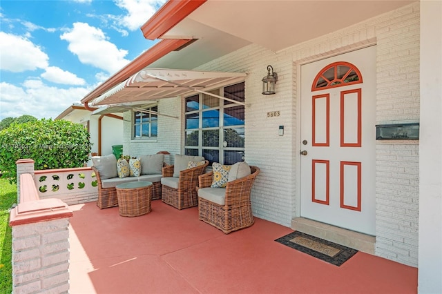 5803 NW 84th Ave, Tamarac, FL 33321 - view of exterior entry with brick siding and an outdoor living space