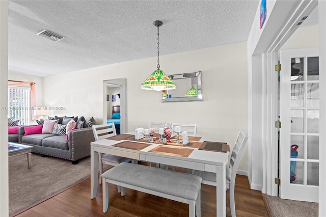 5803 NW 84th Ave, Tamarac, FL 33321 - dining area featuring wood finished floors, a textured ceiling, and visible vents