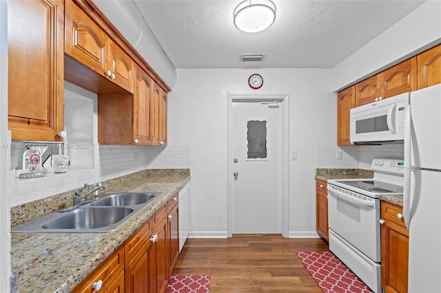 5803 NW 84th Ave, Tamarac, FL 33321 - kitchen with visible vents, decorative backsplash, white appliances, dark wood-type flooring, and a sink