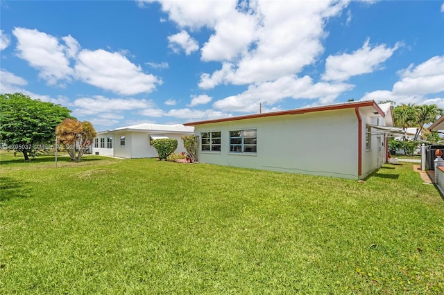 5803 NW 84th Ave, Tamarac, FL 33321 - rear view of property with a yard and stucco siding