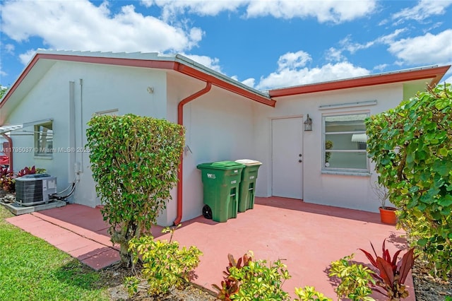 5803 NW 84th Ave, Tamarac, FL 33321 - back of property with cooling unit, a patio area, and stucco siding