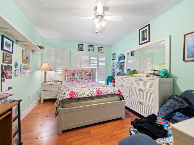 21121 SW 85th Ave Unit 202, Cutler Bay, FL 33189 - bedroom featuring a ceiling fan, a textured ceiling, and wood finished floors