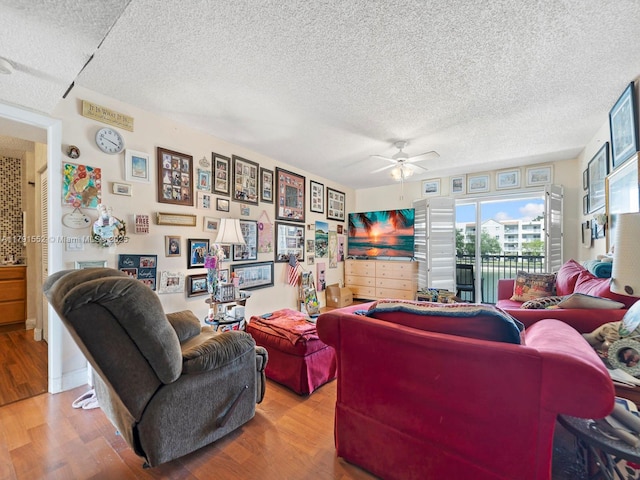 21121 SW 85th Ave Unit 202, Cutler Bay, FL 33189 - living area featuring a ceiling fan, a textured ceiling, and wood finished floors