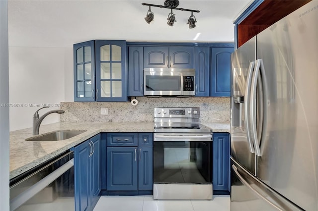 1901 NW S River Dr Unit 14-B, Miami, FL 33125 - kitchen featuring stainless steel appliances, blue cabinets, a sink, light stone counters, and glass insert cabinets