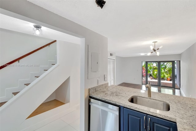 1901 NW S River Dr Unit 14-B, Miami, FL 33125 - kitchen with blue cabinets, dishwasher, a sink, a chandelier, and light stone countertops
